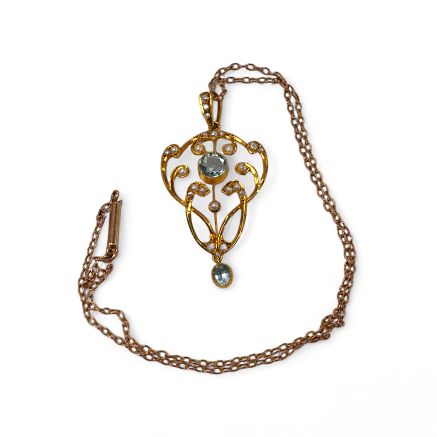 An Edwardian 9ct and gem set drop pendant, 45mm, on a yellow metal fine link chain, 36cm, gross weight 4.2 grams. Condition - good